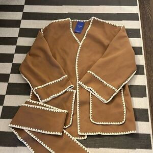 Never worn with tags comes with belt fleece material, not lined on the interior